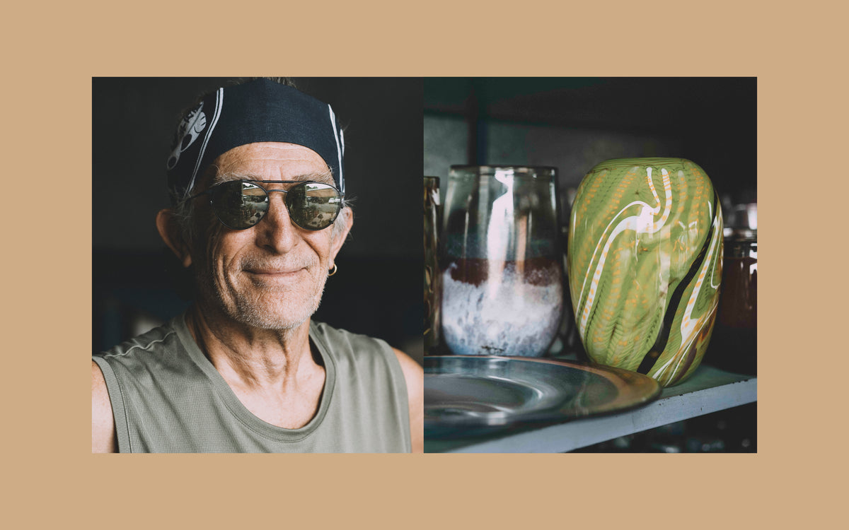 Keith Rowe on the left, and blown glass vases he has created, on the right.