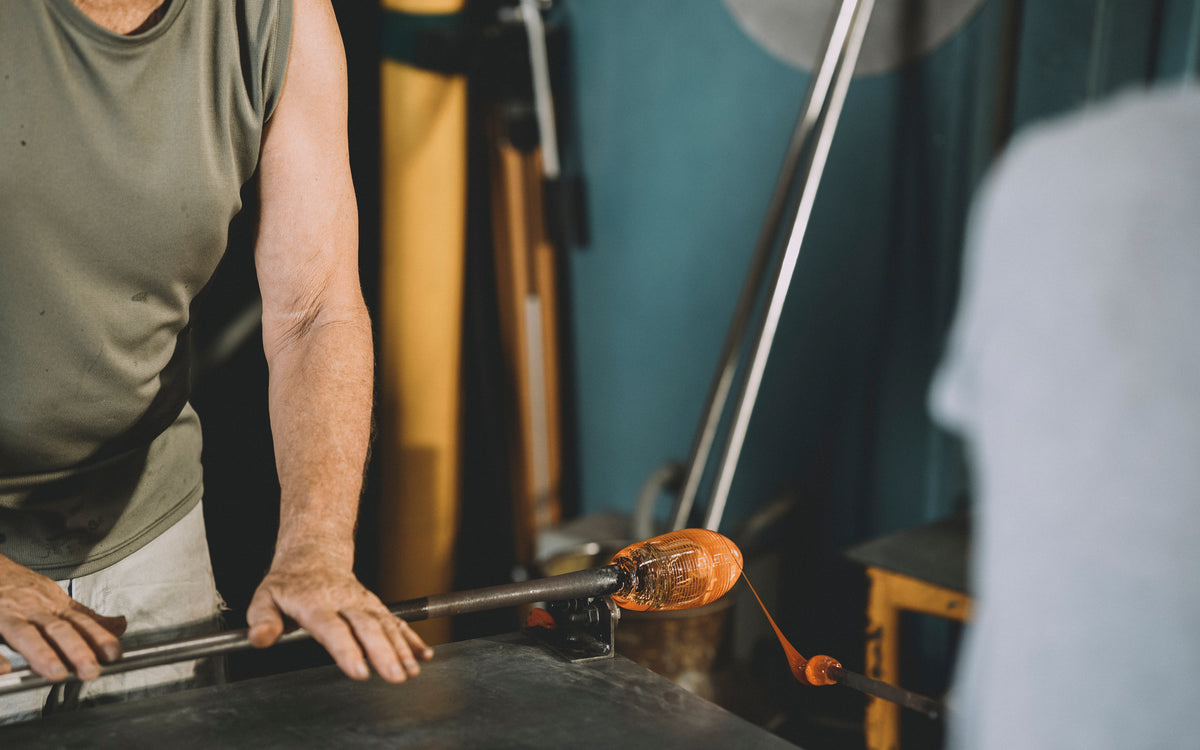 Ketih Rowe working with molten glass in his glass blowing studio